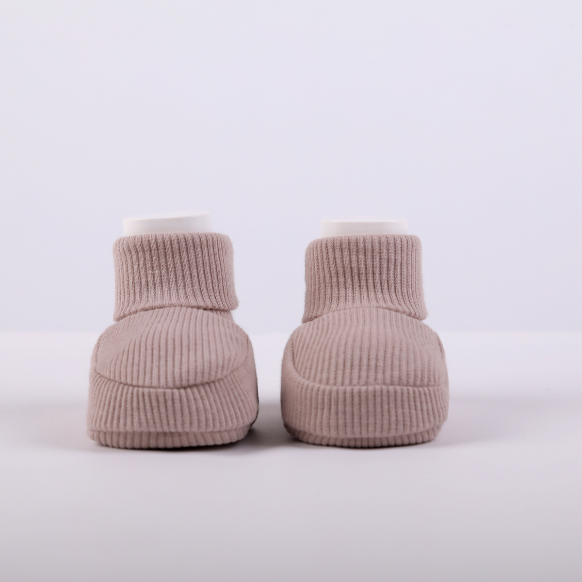 Organic cotton baby booties in rose gold, front view