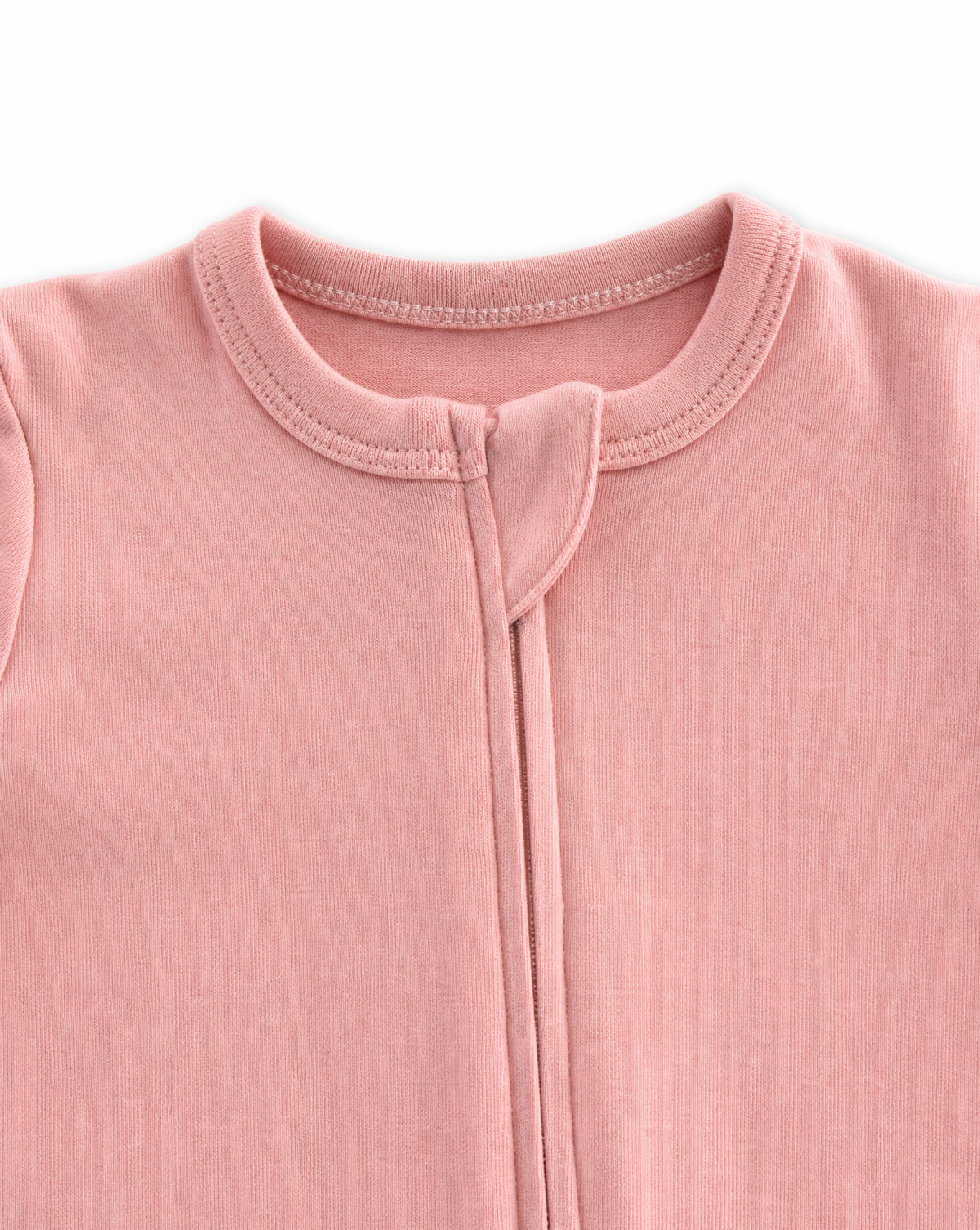 Close-up of a baby romper in dusty pink, showing the front zipper, collar, and ribbed fabric texture against a white background.