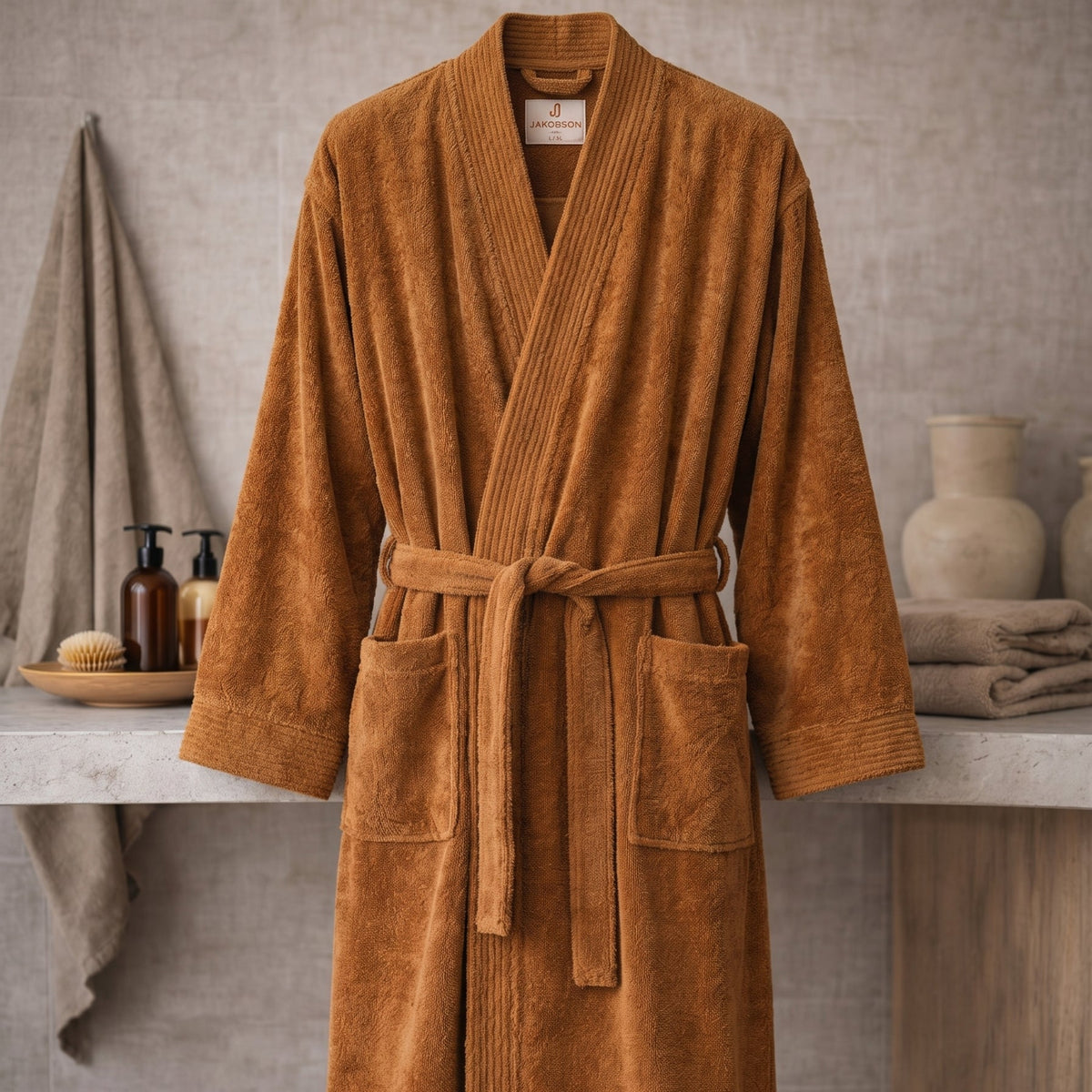 Cinnamon bathrobe on a stone surface with a neutral background