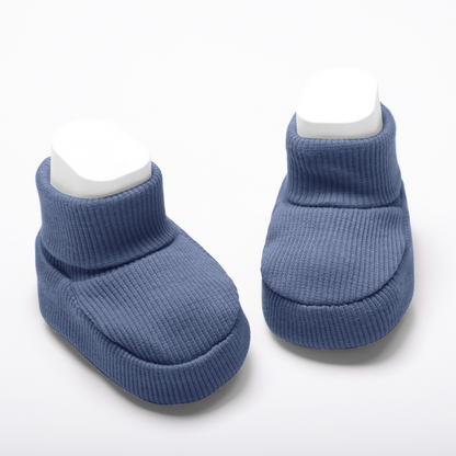 Organic cotton baby booties in navy blue on a white background for newborn comfort
