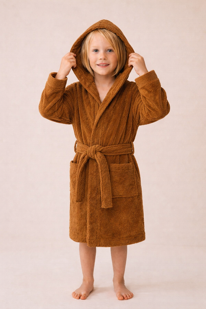 Child wearing organic children's terry bathrobe in cinnamon made from 100% organic cotton