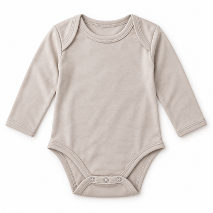 A long-sleeve baby bodysuit in a light taupe-beige color, featuring three snap buttons at the crotch, laid flat on a white background.